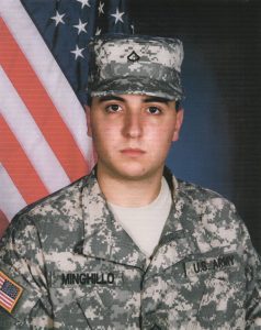 a man in military uniform standing in front of an american flag