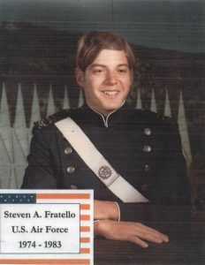 a man in military uniform posing with his hands crossed on a table