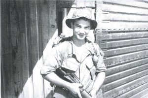a man in a military uniform holding a weapon