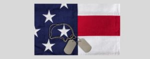 Salute to Veterans folded flag with dog tags laying on top