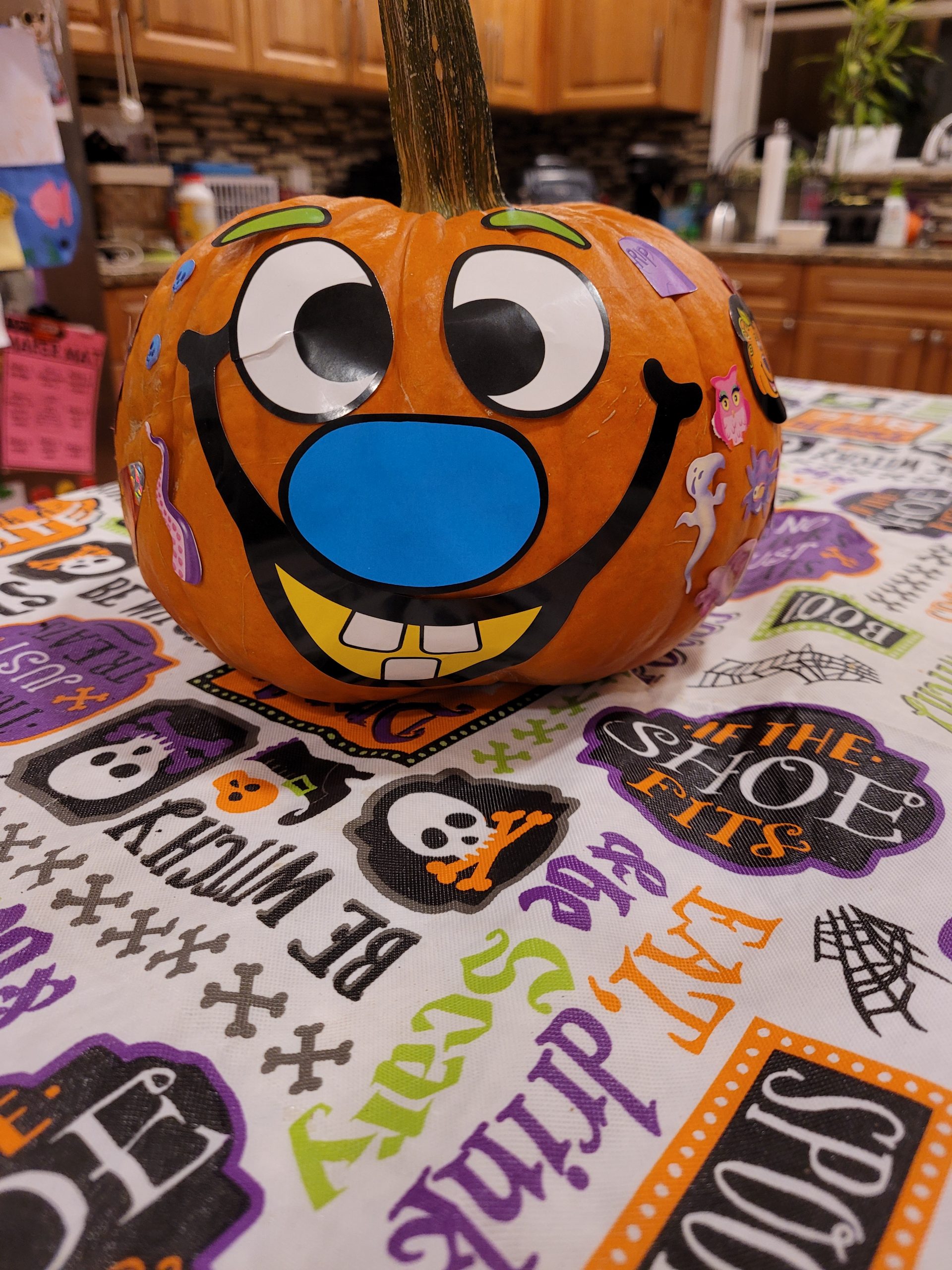 A pumpkin decorated with a funny face on a table