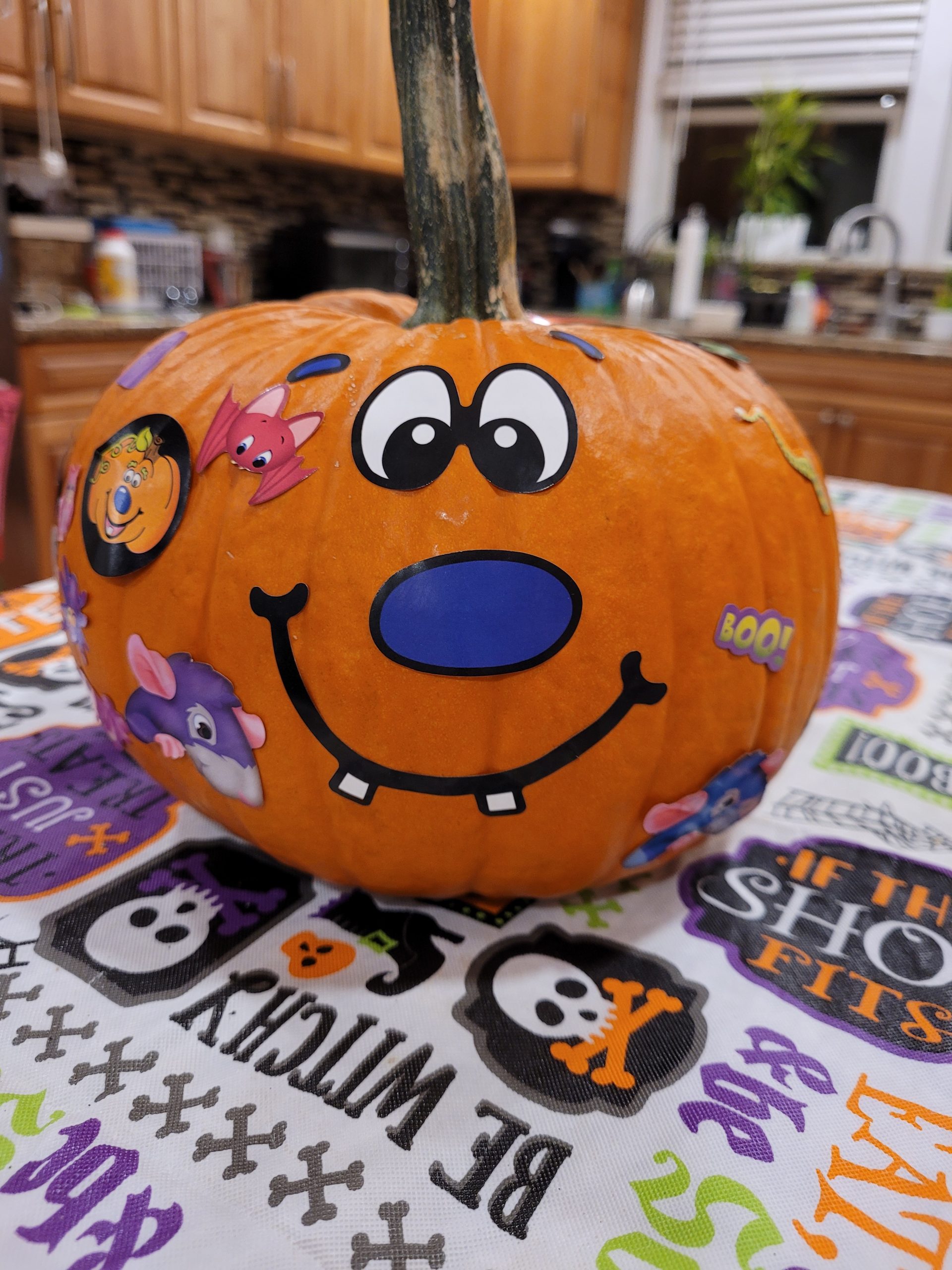 A pumpkin decorated with a smiley face on a table
