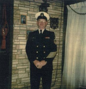 a man in military uniform standing in front of a wall with pictures