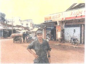 a man in military uniform standing near a row of shops
