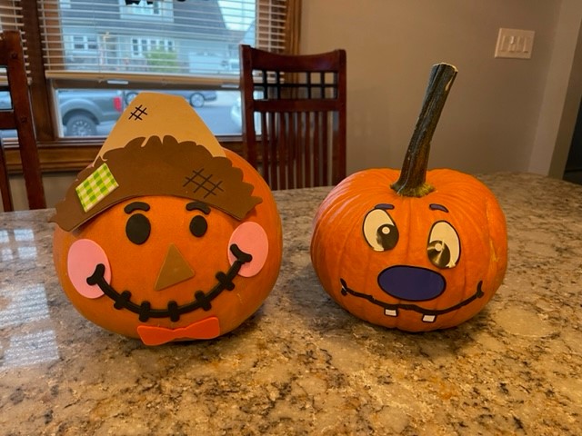 two decorated pumpkins on a table