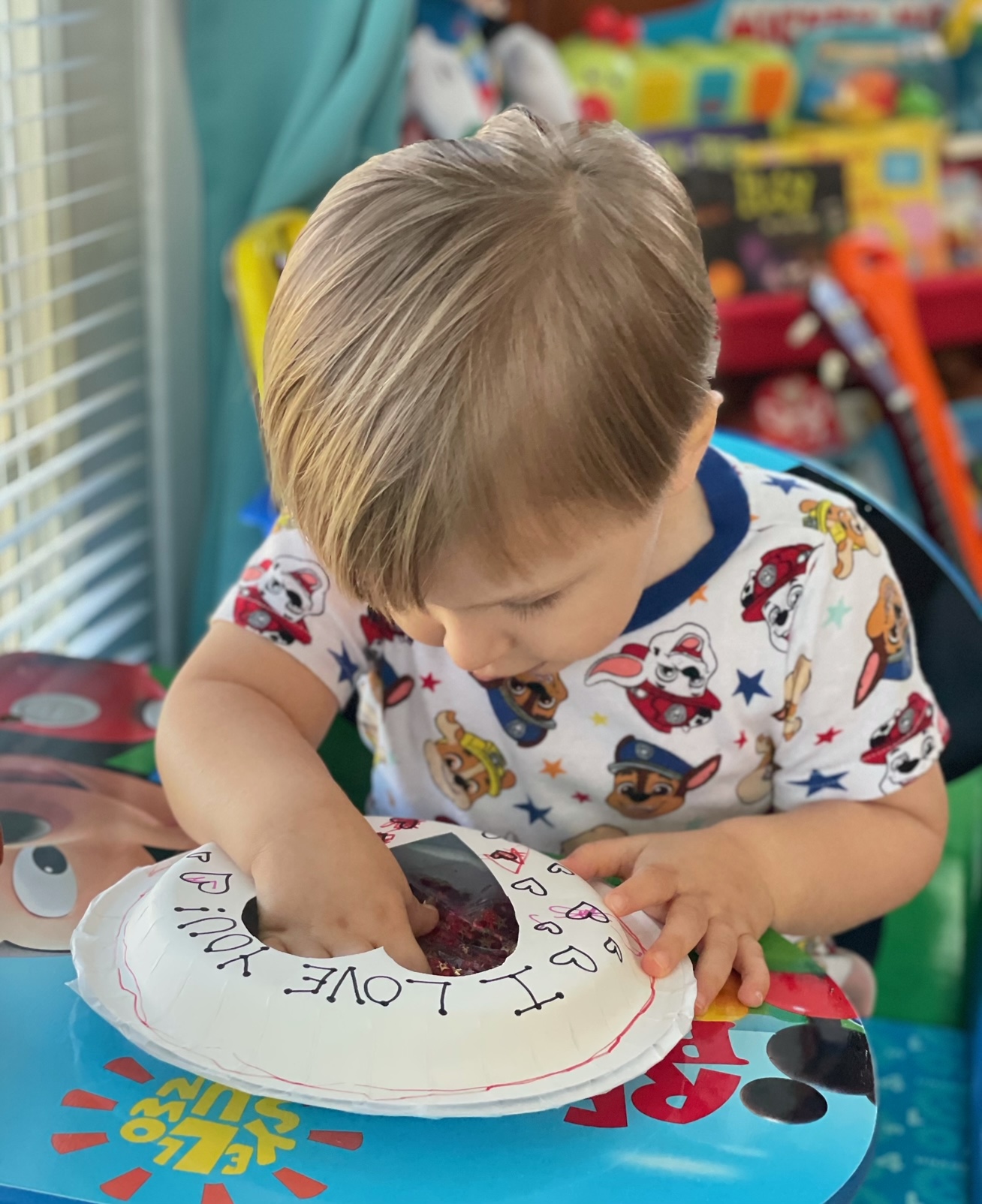 a child creating a heart sensory craft