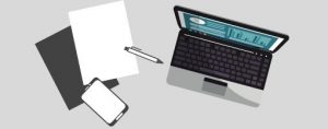 a laptop with a binder and pen also with a mobile phone