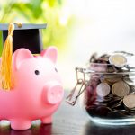 Save money coins in grass jar with piggy bank and graduation cap, Business finance education concept.