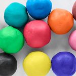 Multicolor plasticine balls closeup as a background