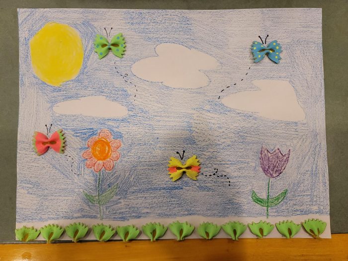 A kids drawing of the sky with pasta butterflies painted different colors flying around.