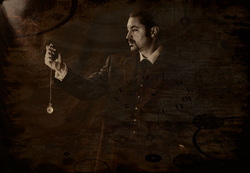 A sepia-toned picture of a man holding a dangling pocket watch.
