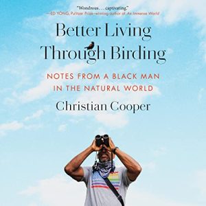 Better Living Through Birding by Christian Cooper book cover with a picture of the author against a blue sky backdrop holding binoculars to his eyes and looking up.