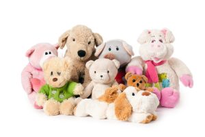 Various stuffed animals sitting in a group.