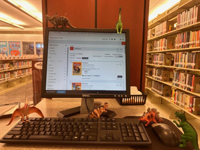 toy dinosaurs on library opac machine