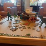 toy dinosaurs on puzzle pieces