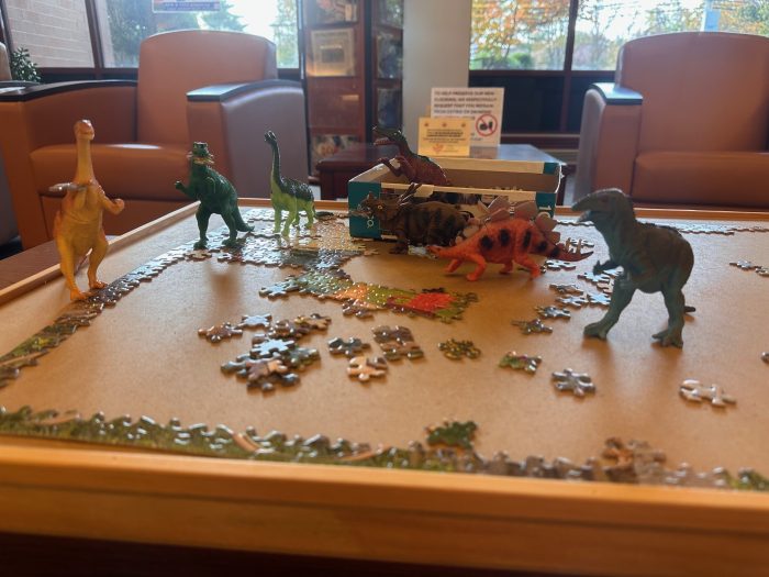 toy dinosaurs on puzzle pieces