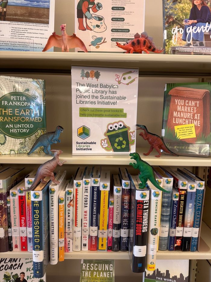 toy dinosaurs on sustainability shelf in library