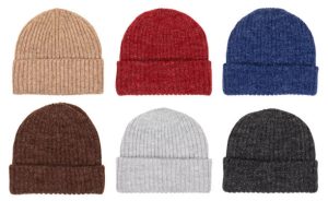 Collection of knit winter beanie hats of various colors isolated on white background