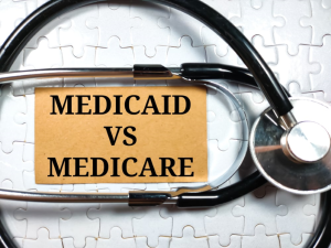 Medicare vs. Medicaid with a stethoscope around the words. 
