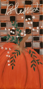 A pumpkin against a checkered background with the work Blessed written at the top.