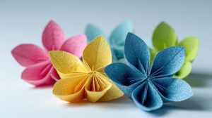 Paper folded to make flowers in pink, yellow, blue, and green.