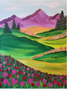 Pink tulips in the foreground of a forest scene with purple mountains in the background.