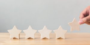 5 wooden stars in a row on a table