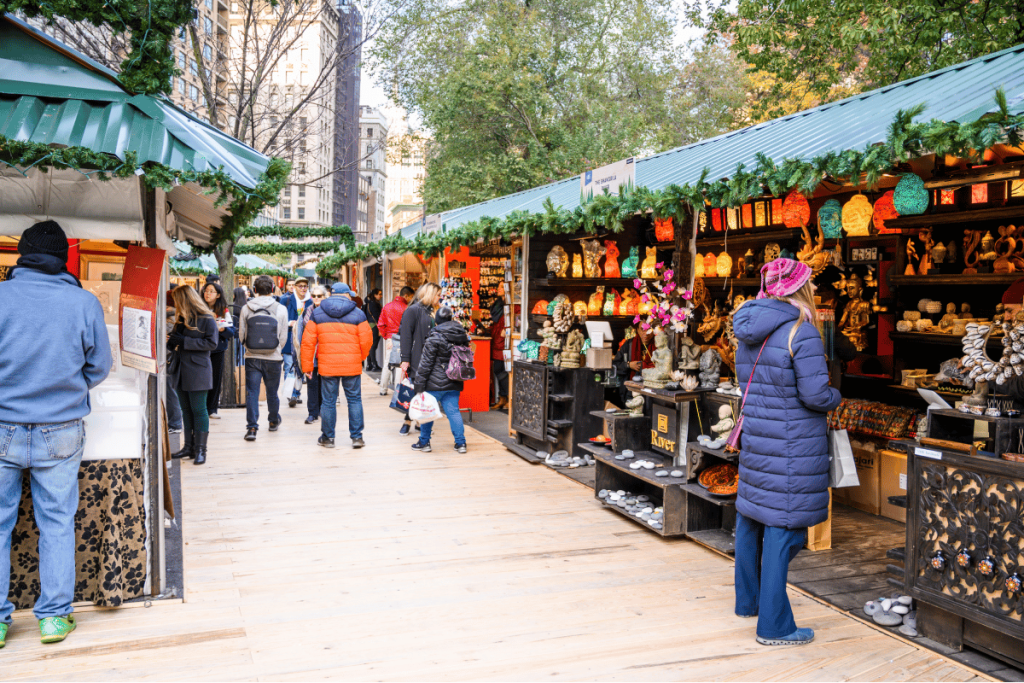 An outdoor market with stalls and people shopping