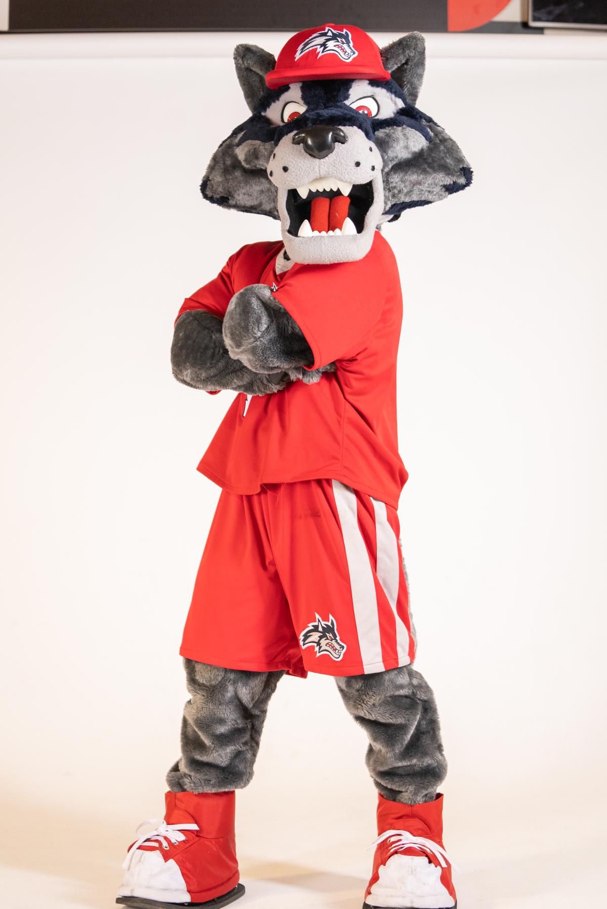 Wolfie mascot standing with his arms crossed